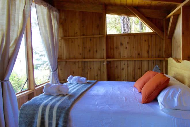A handcrafted log bed in a west coast resort cabana