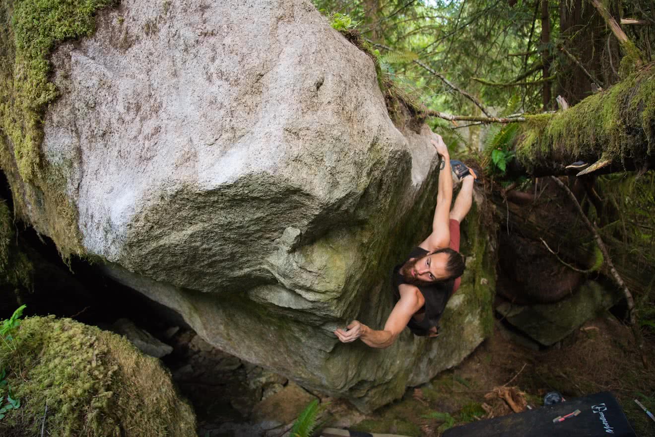 A local climbing a bouldering problem in the Eldred Valley