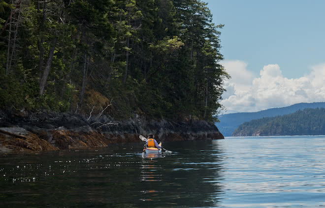 A guest at the resort on a Guided Kayak Package