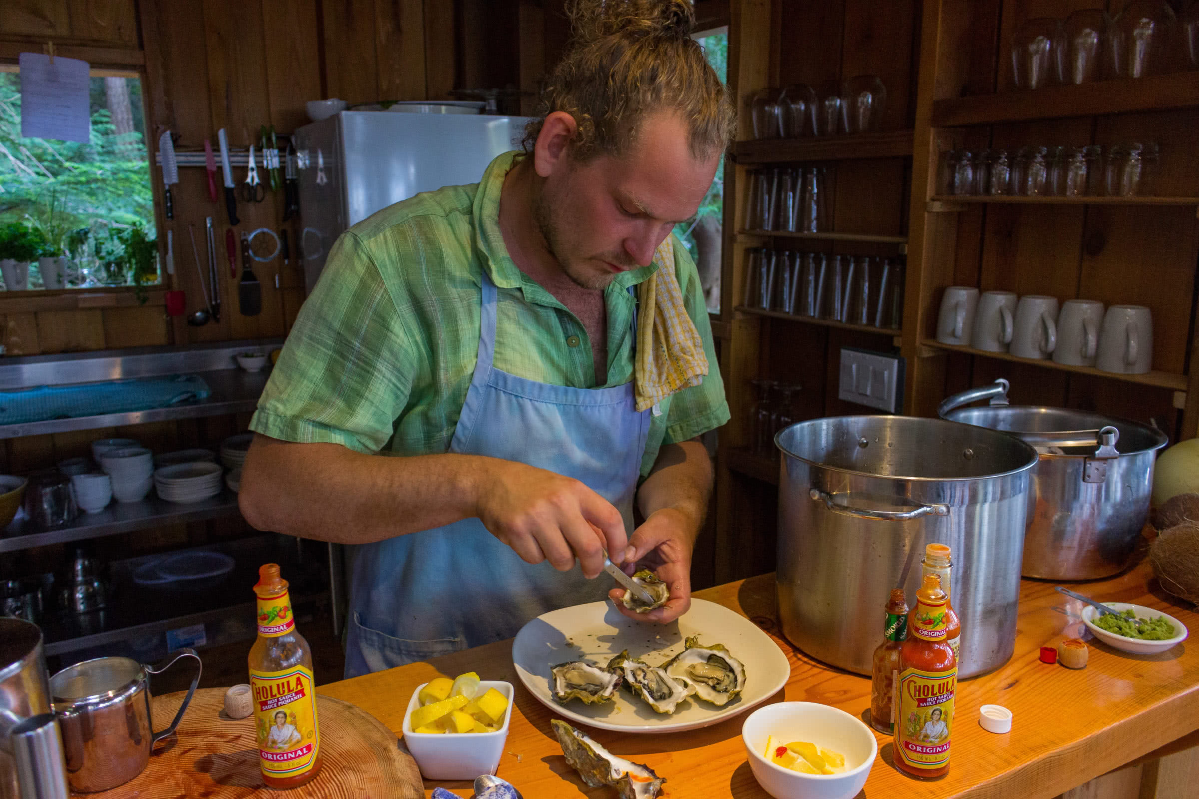 Our cook serving fresh oysters at the Cabana Cafe at the off-grid eco resort