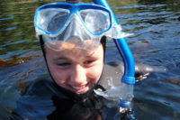 A happy young snorkeler comes up for air in Desolation Sound
