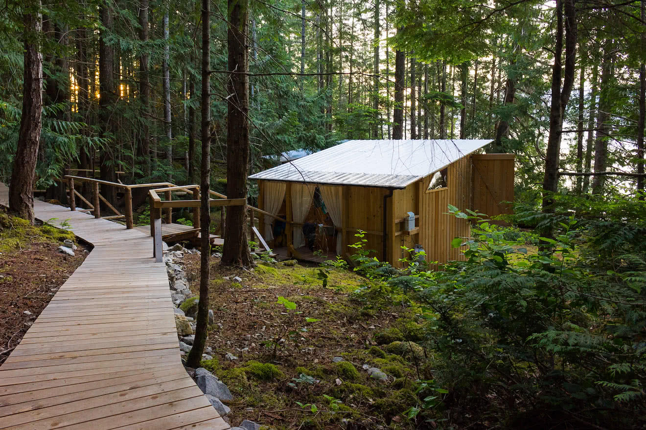 A cedar boardwalk connects handcrafted cabanas at this west coast eco resort