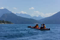 A kayaker stops to take a photo on a guided kayak package