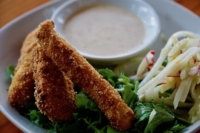 Breaded fish sticks and side salad with a tartare sauce