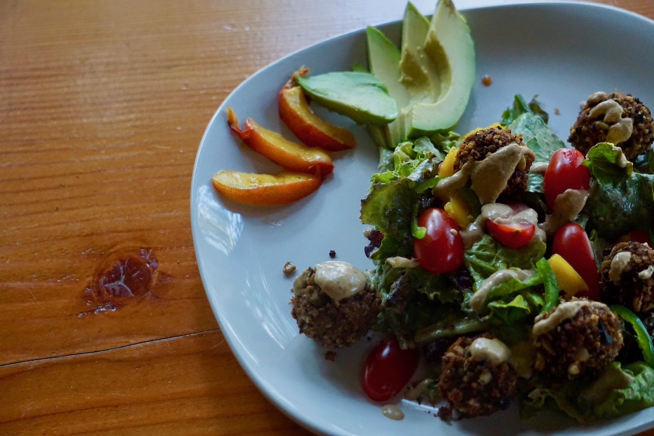 A tasty vegetarian quinoa black bean felafel salad with avocado and peach slices at Cabana Desolation Eco Resort