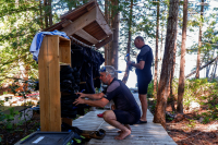 Two men getting dressed into wetsuits to go snorkeling at Cabana Desolation Eco Resort