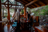 Friends sitting down to dinner with a relaxed ambiance at Cabana Desolation Eco Resort